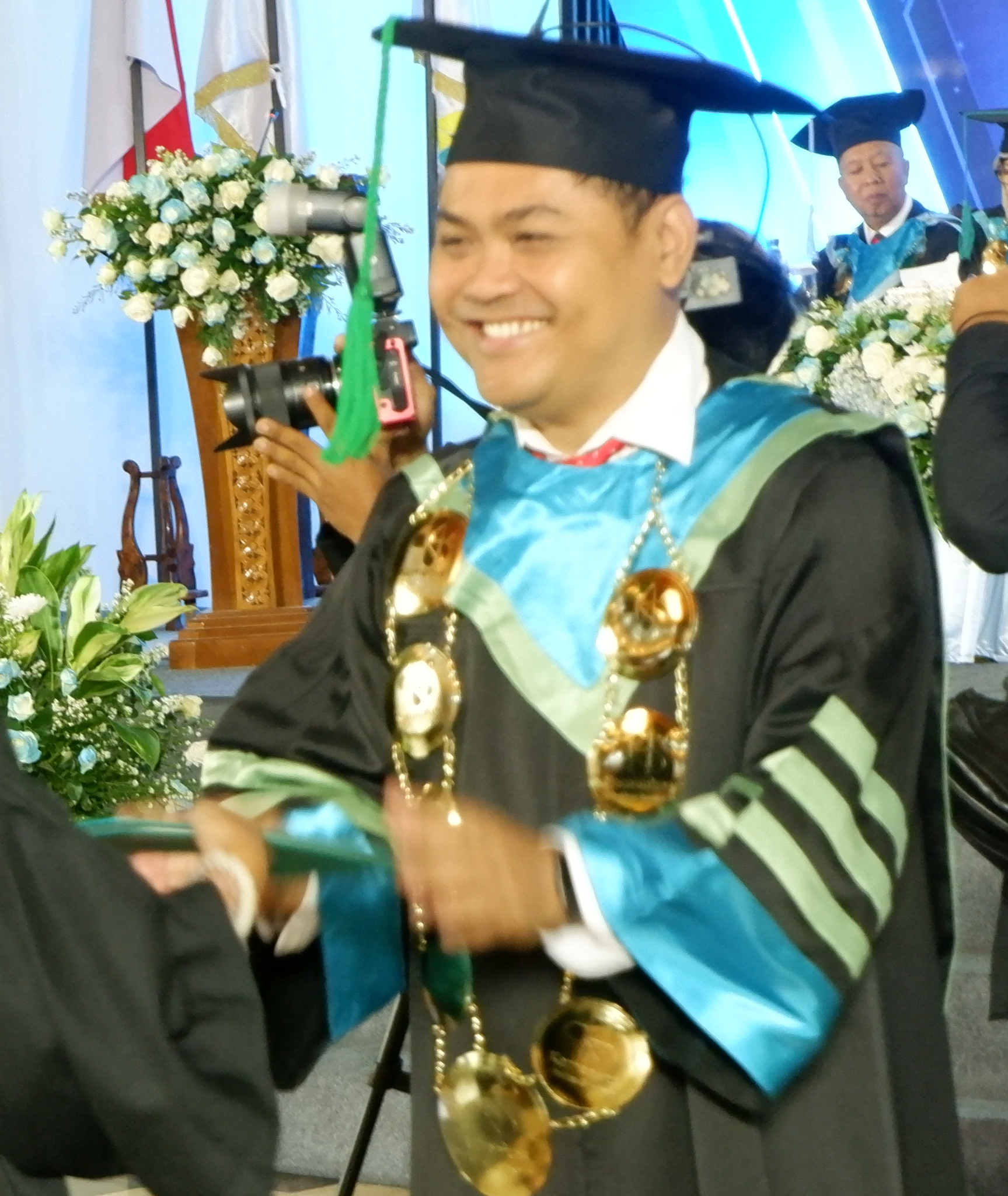 Dr. Nur Rachmat wearing academic regalia